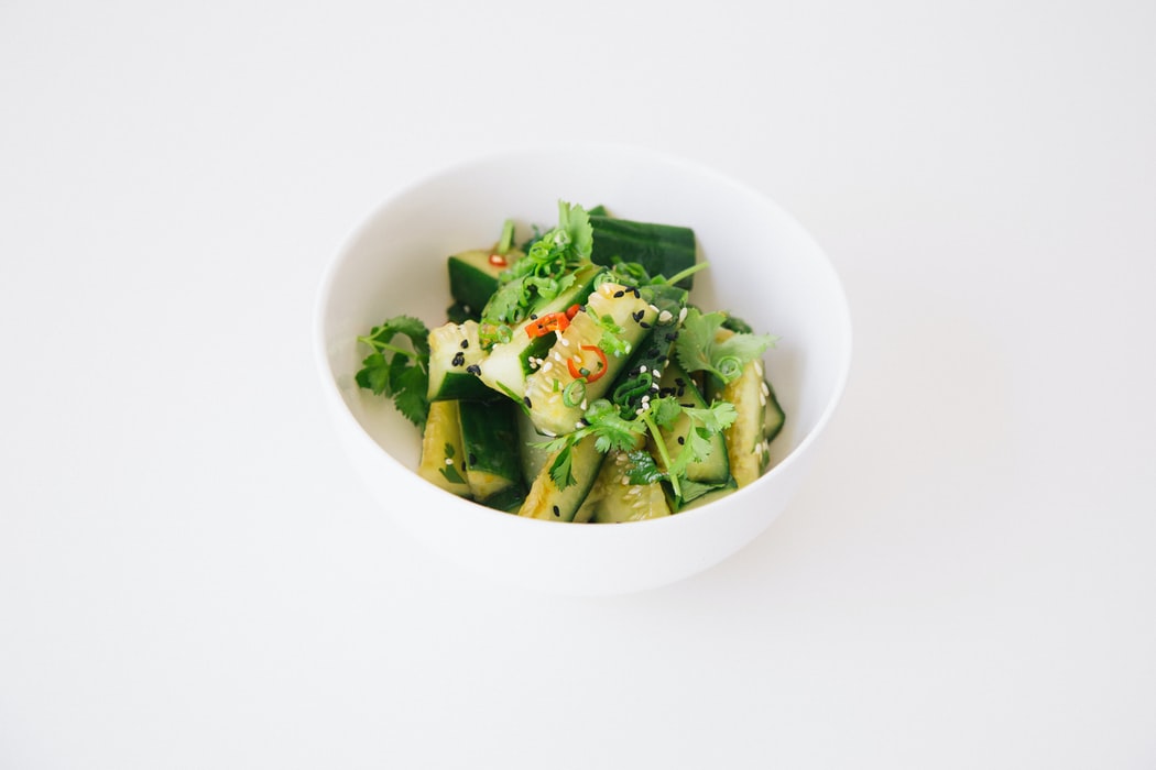 Chinese Cucumber Salad on the table by itself, white background